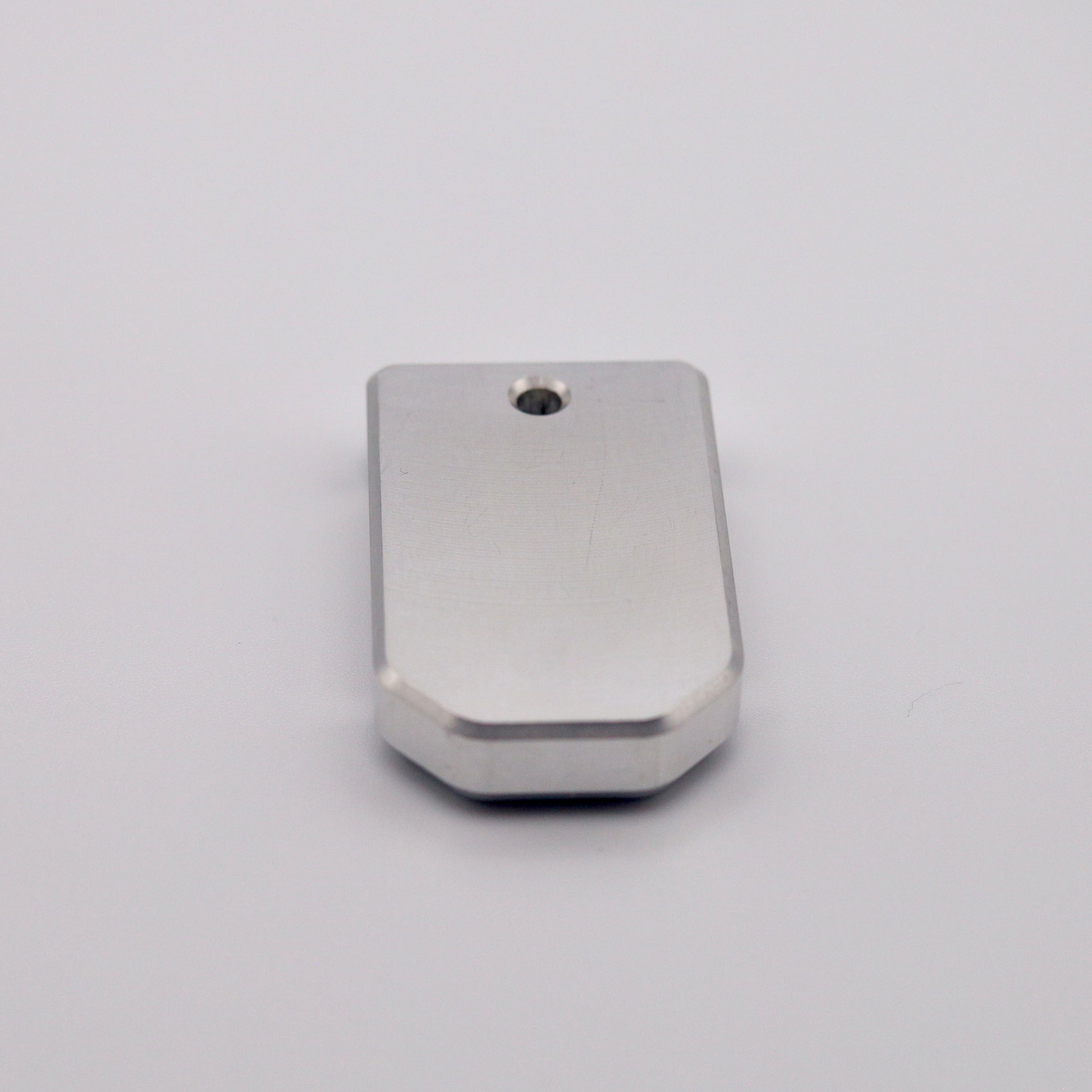 Close-up of machined aluminum base plate for PSA Micro Dagger magazines.